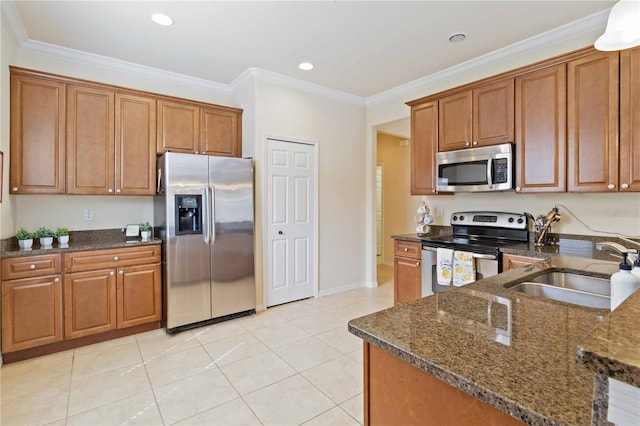 kitchen with sink, appliances with stainless steel finishes, ornamental molding, and dark stone counters