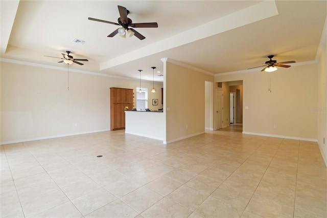 tiled spare room featuring ceiling fan, a tray ceiling, and ornamental molding