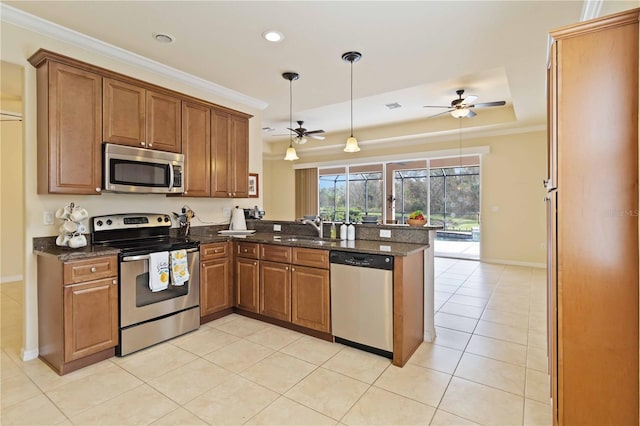 115 Winding River Trl, Bradenton, FL 34212 - kitchen featuring stainless steel appliances, ceiling fan, a peninsula, a sink, and brown cabinetry