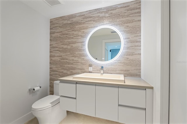 bathroom with toilet and vanity