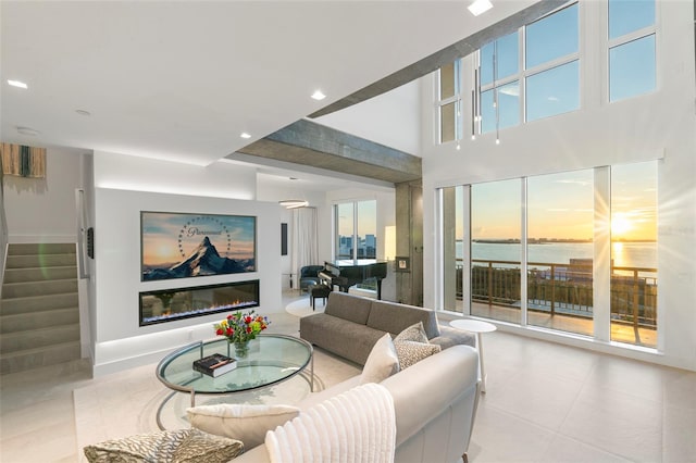 living room featuring plenty of natural light and a water view