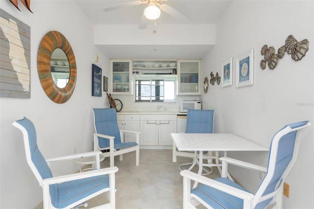 interior space with sink and ceiling fan