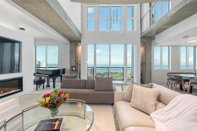 living room featuring plenty of natural light and a water view