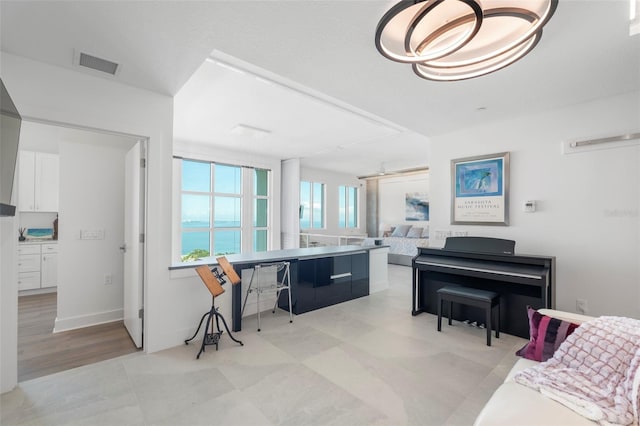 home office with a water view and light hardwood / wood-style flooring