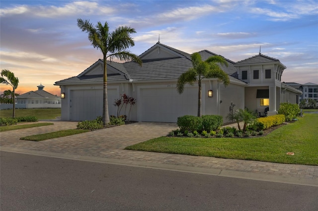 view of front of home with a yard and a garage