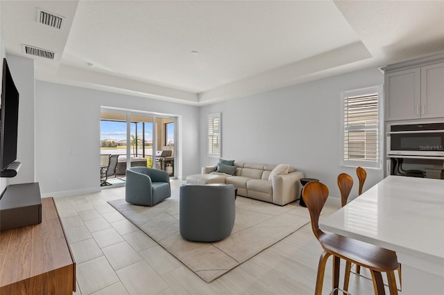 living room with a tray ceiling