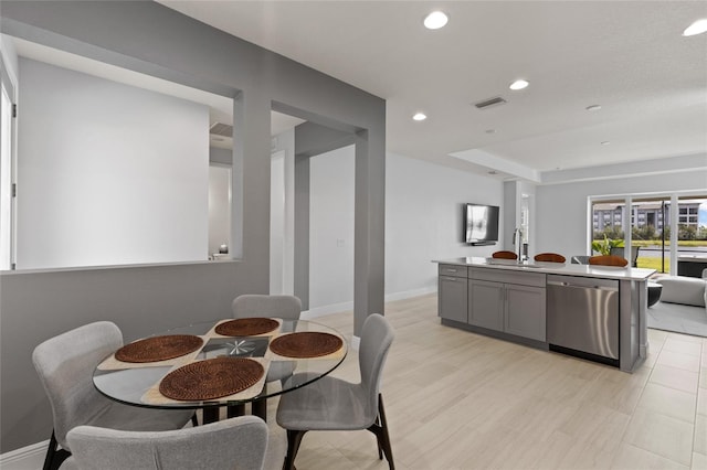 dining room with light hardwood / wood-style flooring and sink