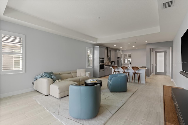 living room featuring a tray ceiling