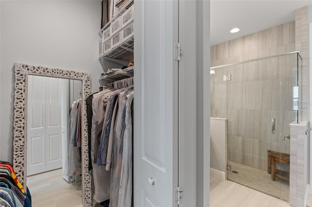 interior space with a tile shower and hardwood / wood-style flooring