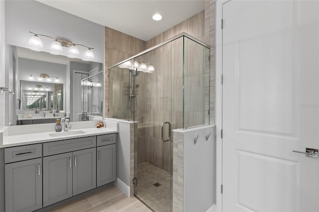 bathroom with vanity and a shower with shower door