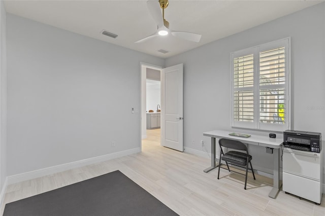 office area with light wood-type flooring and ceiling fan