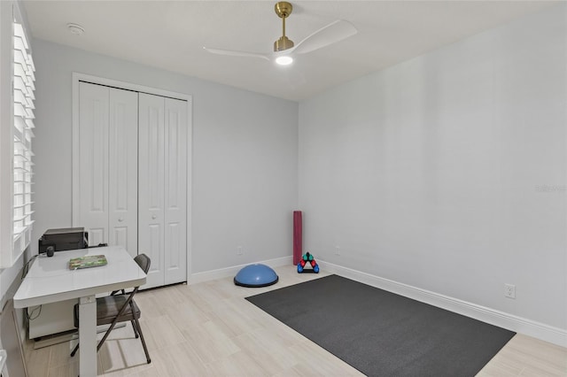 workout area with light hardwood / wood-style floors and ceiling fan