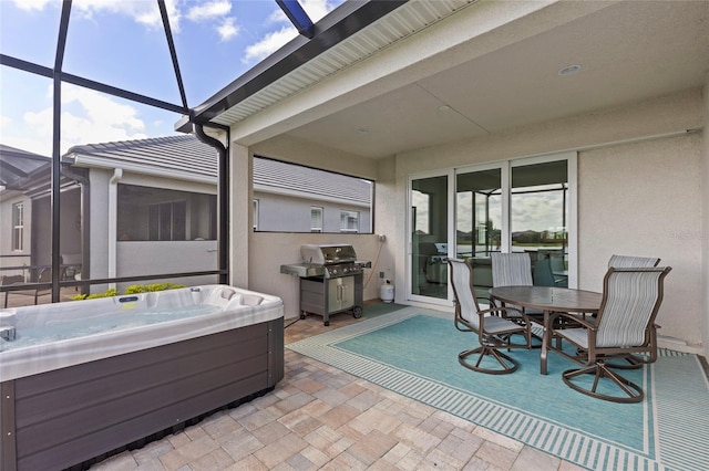 view of patio with a hot tub, a lanai, and a grill