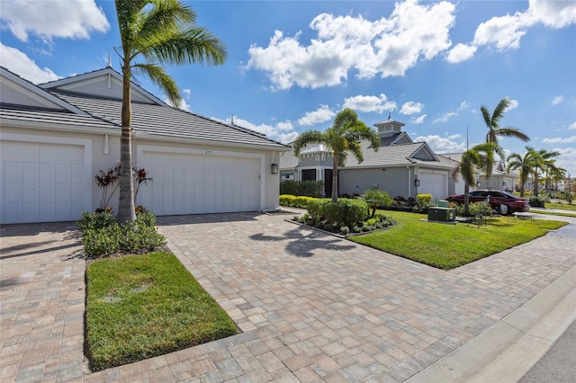 view of front of house with a front yard and a garage