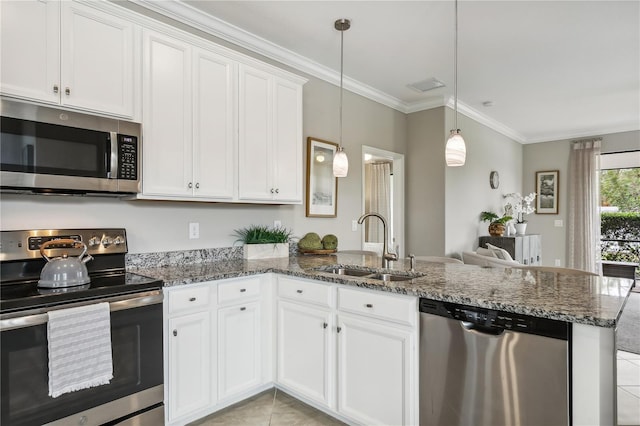 kitchen featuring white cabinetry, kitchen peninsula, pendant lighting, appliances with stainless steel finishes, and ornamental molding