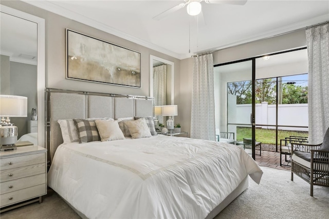 carpeted bedroom featuring ceiling fan and crown molding