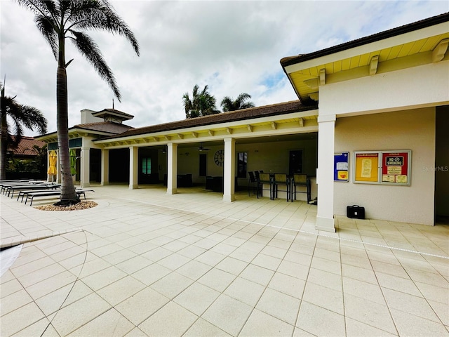 view of patio / terrace with ceiling fan and exterior bar