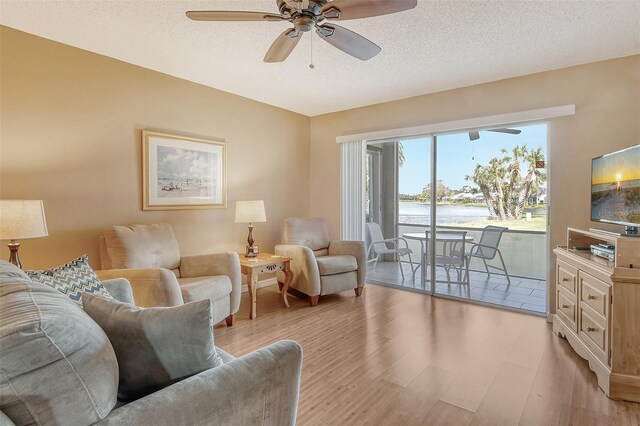 9320 Clubside Cir Unit 2109, Sarasota, FL 34238 - living area with ceiling fan, a textured ceiling, and light wood-type flooring