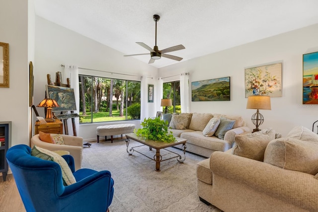 living room with light hardwood / wood-style floors, lofted ceiling, and ceiling fan