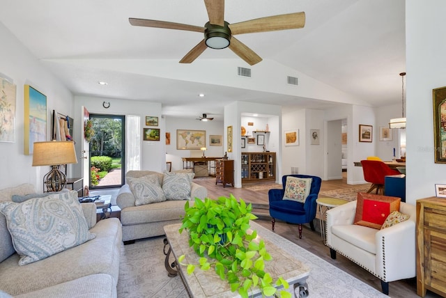 living room featuring lofted ceiling, ceiling fan, and wood-type flooring