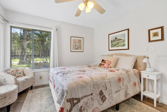 bedroom with wood-type flooring and ceiling fan