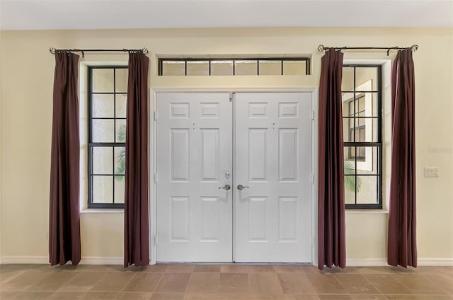 doorway with light tile patterned flooring