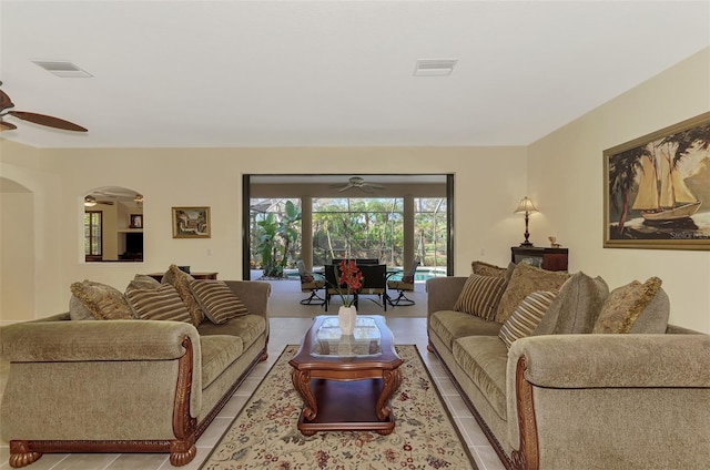 tiled living room featuring ceiling fan