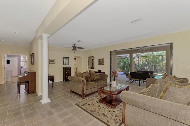 tiled living room with ornate columns and ceiling fan