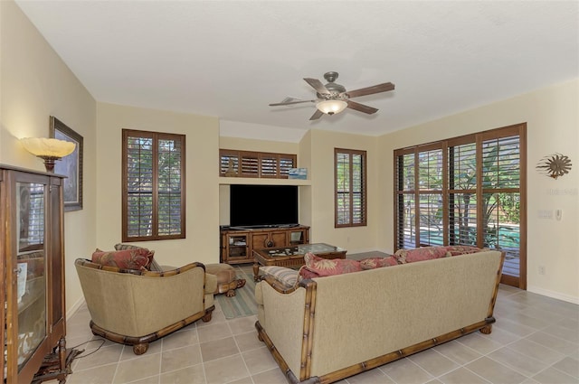 tiled living room featuring ceiling fan and a healthy amount of sunlight