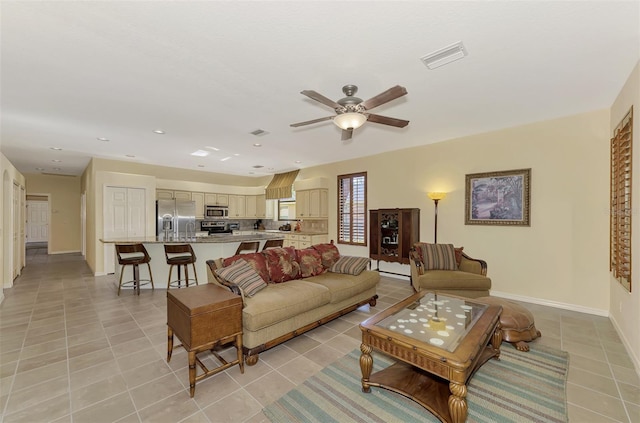 living room with light tile patterned floors and ceiling fan