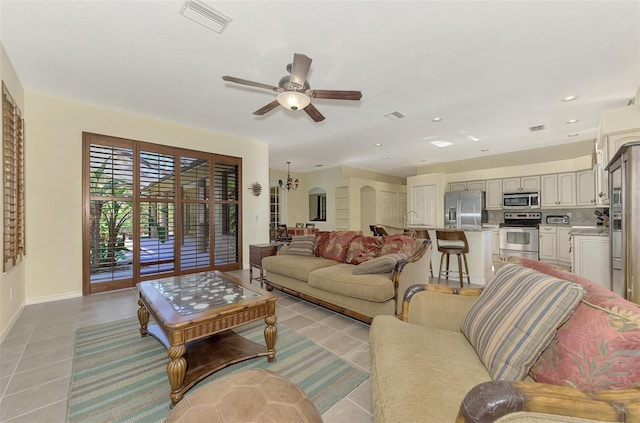 tiled living room featuring sink and ceiling fan