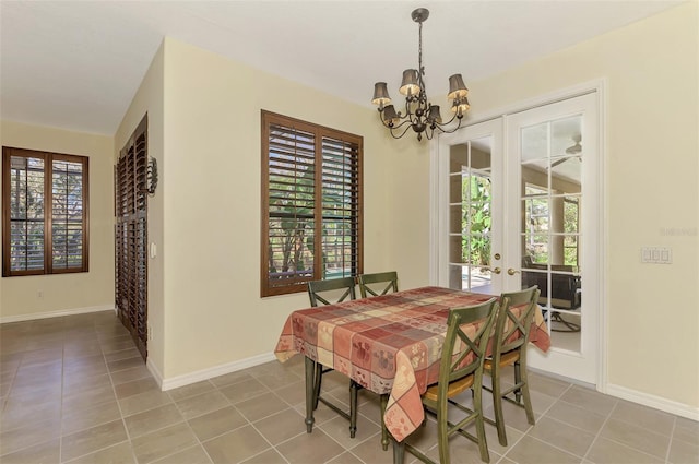 tiled dining room with a notable chandelier and a wealth of natural light