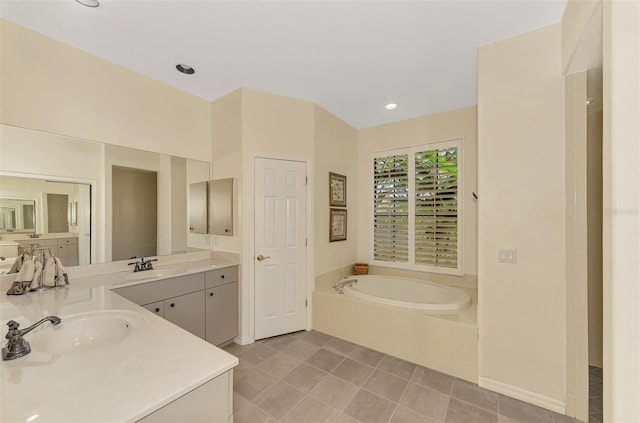 bathroom featuring vanity and tiled tub