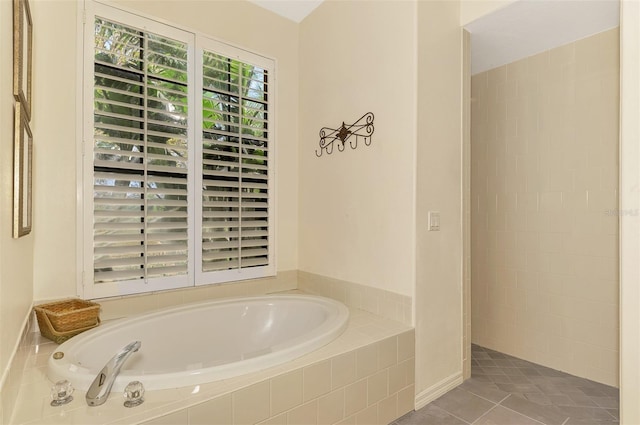 bathroom featuring tiled tub and tile patterned floors