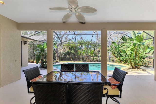 view of patio / terrace with ceiling fan and a lanai