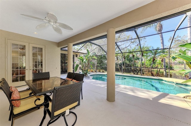 view of swimming pool with french doors, a patio area, glass enclosure, and ceiling fan