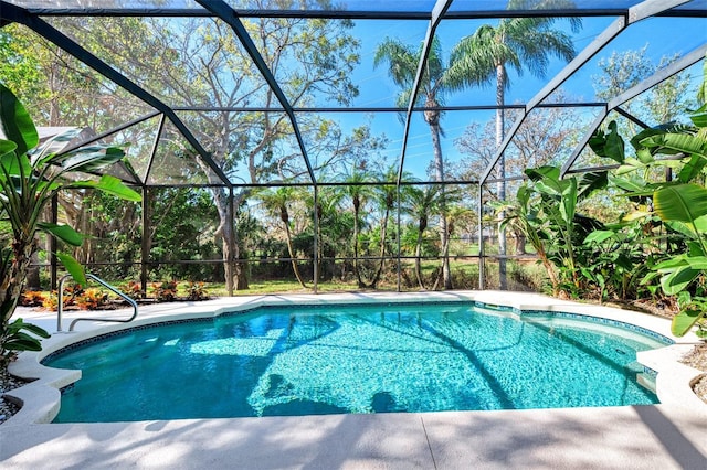 view of pool with glass enclosure