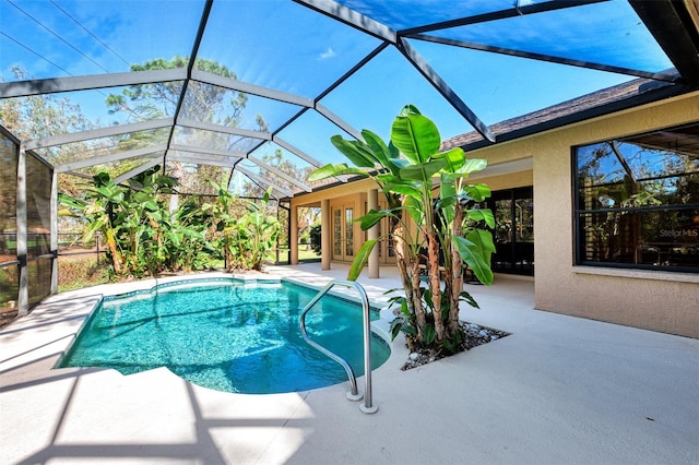 view of pool with a patio, french doors, and glass enclosure