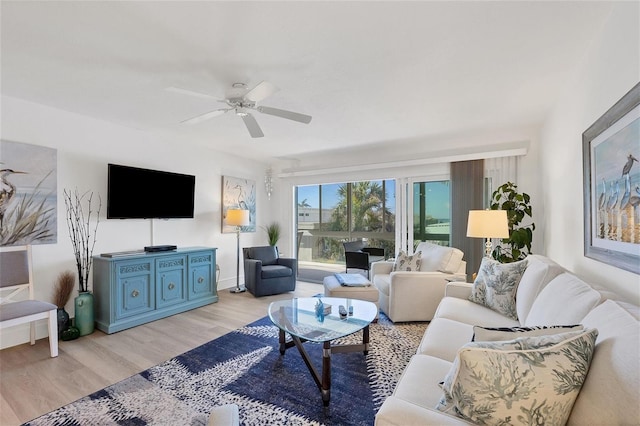 living room featuring ceiling fan and light hardwood / wood-style flooring