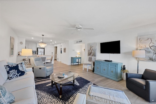 living room featuring ceiling fan and light wood-type flooring