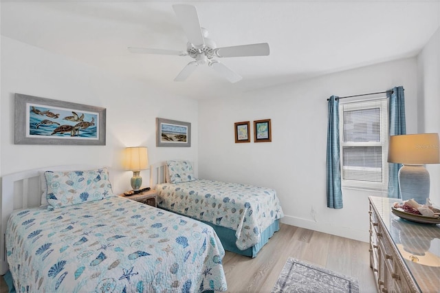 bedroom with light hardwood / wood-style flooring and ceiling fan