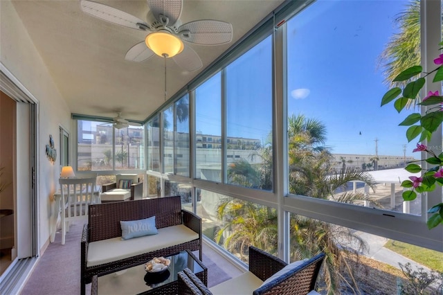 sunroom featuring ceiling fan