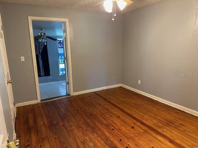 unfurnished room featuring hardwood / wood-style floors, a textured ceiling, and ceiling fan