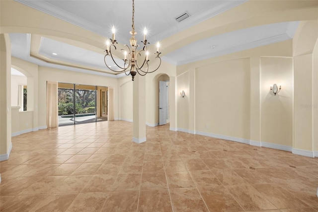 empty room with a tray ceiling, light tile patterned flooring, ornamental molding, and a notable chandelier