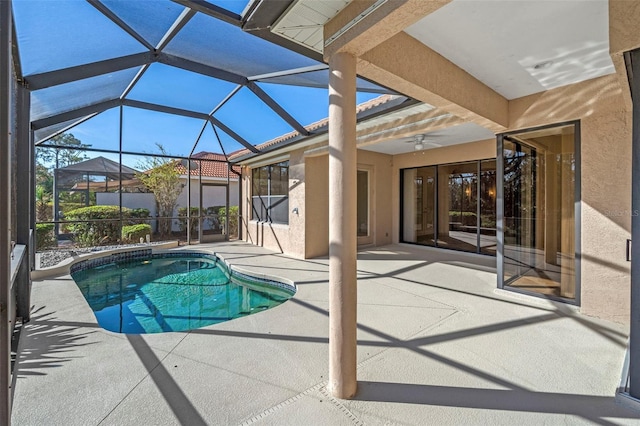 view of swimming pool with glass enclosure, ceiling fan, and a patio