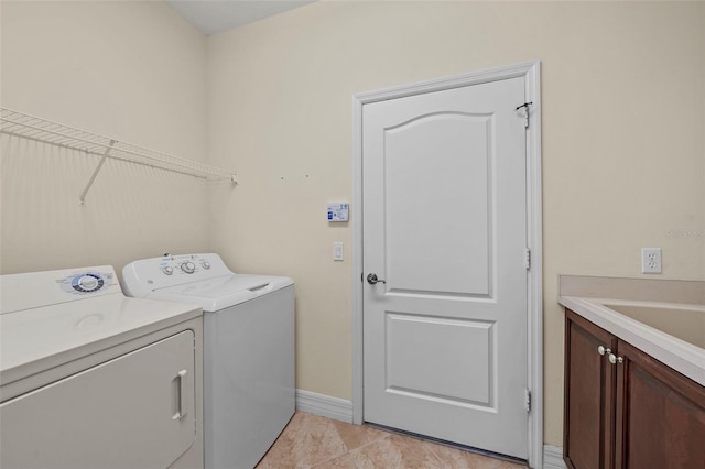 laundry area featuring cabinets, independent washer and dryer, and light tile patterned floors