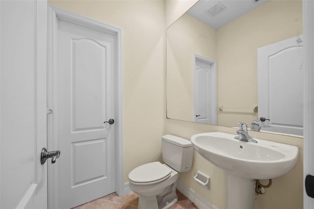 bathroom featuring tile patterned flooring and toilet