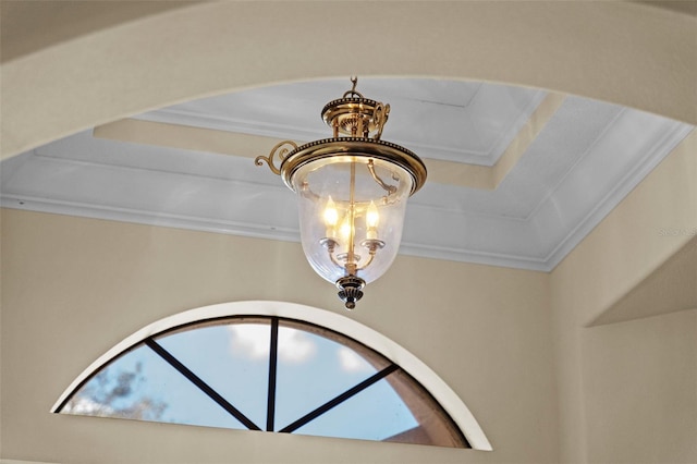 interior details featuring crown molding and a notable chandelier