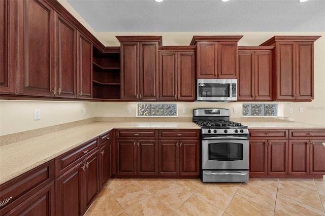 kitchen featuring light countertops, open shelves, and stainless steel appliances