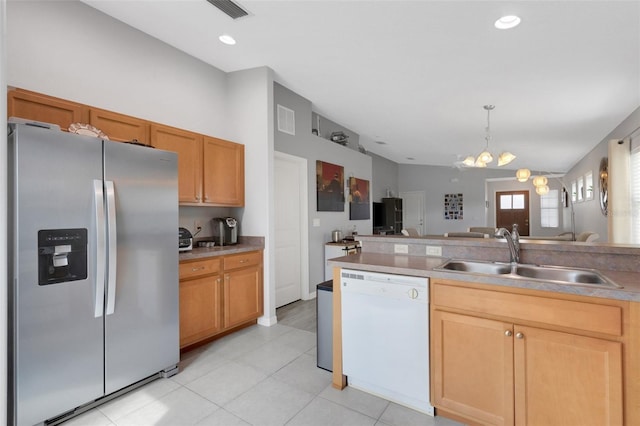 kitchen featuring dishwasher, stainless steel refrigerator with ice dispenser, hanging light fixtures, sink, and a notable chandelier